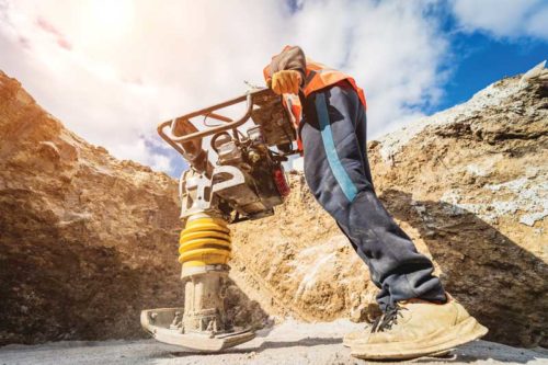 Worker using a portable Vibrator machine