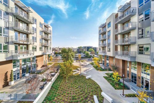 bird's eye view of a row of townhouses with a patch of greenery in between