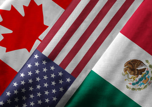 Close up of the flags of the North American Free Trade Agreement NAFTA members on textile texture. NAFTA is the world's largest trade bloc and the member countries are Canada United States and Mexico.