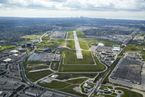 aerial view of a green patch of land with a runway strip