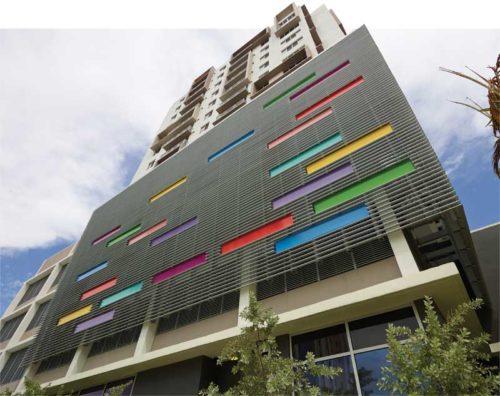 skyscraper with colourful patches on the facade