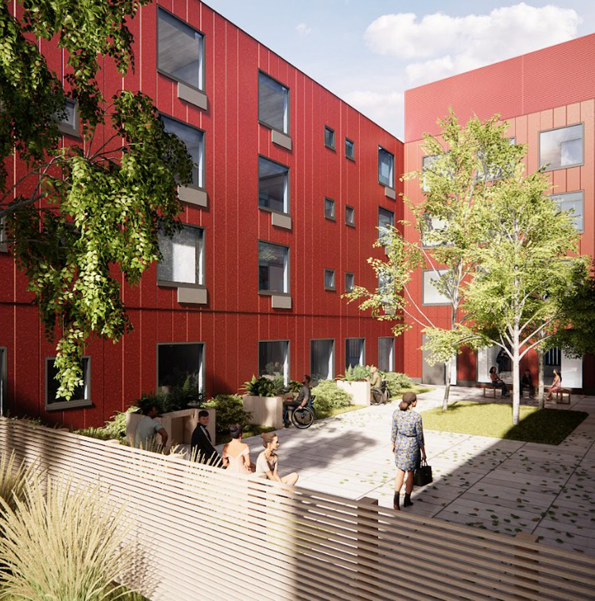 Modern red building with people interacting in an outdoor courtyard setting.